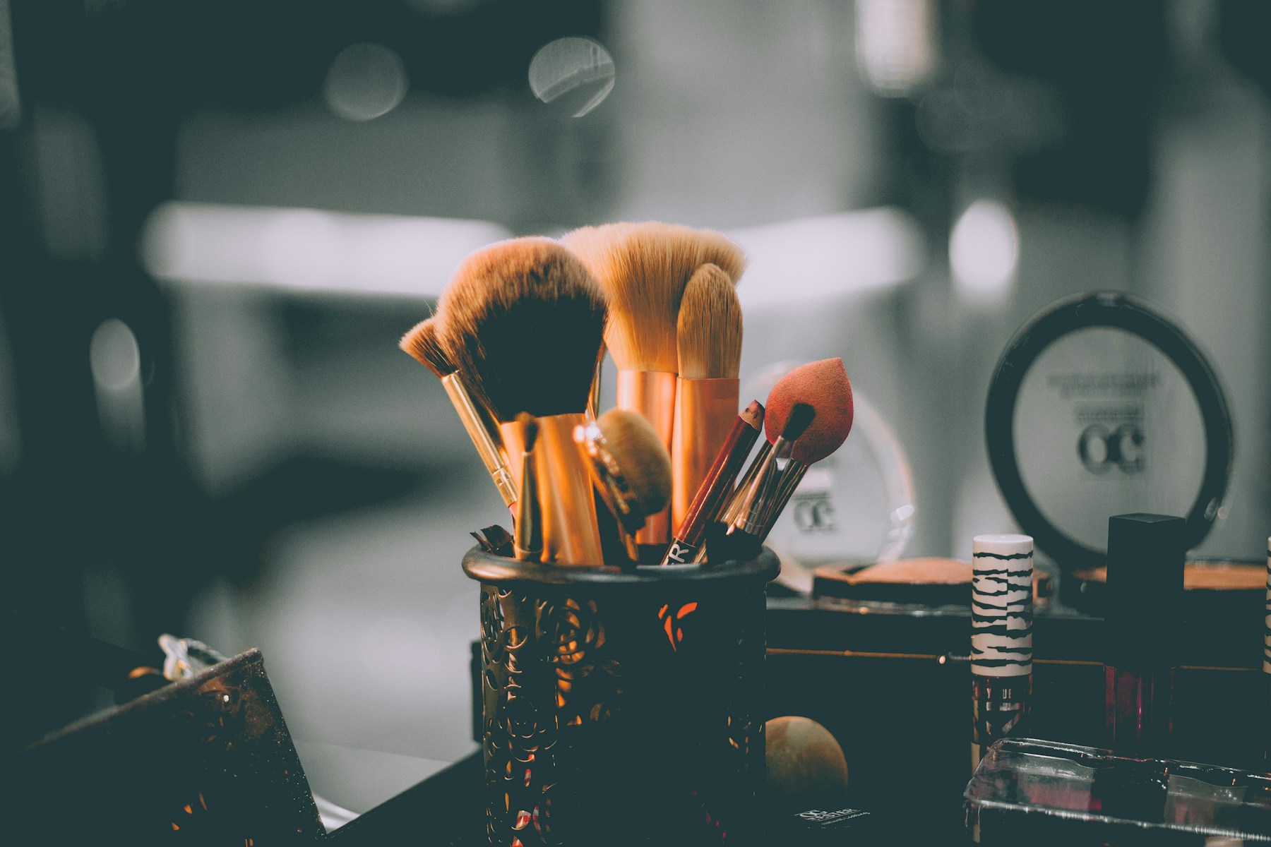 Makeup tools on rose gold surface